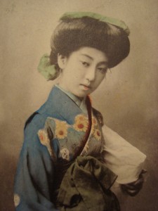 A coloured photographic postcard of Teruha a famous "Nine fingered geisha" popular in the Meiji period